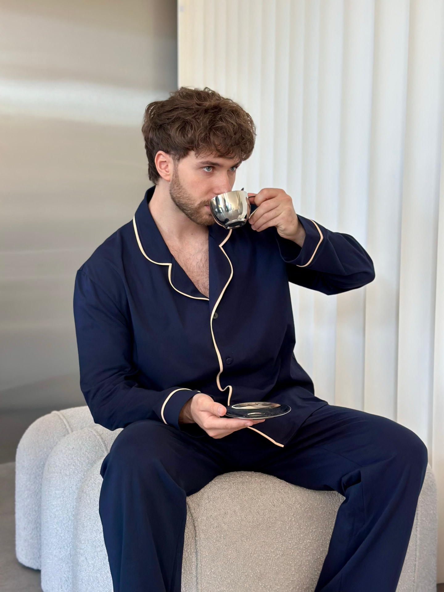 COSY lifestyle — man in navy pajamas with coffee
